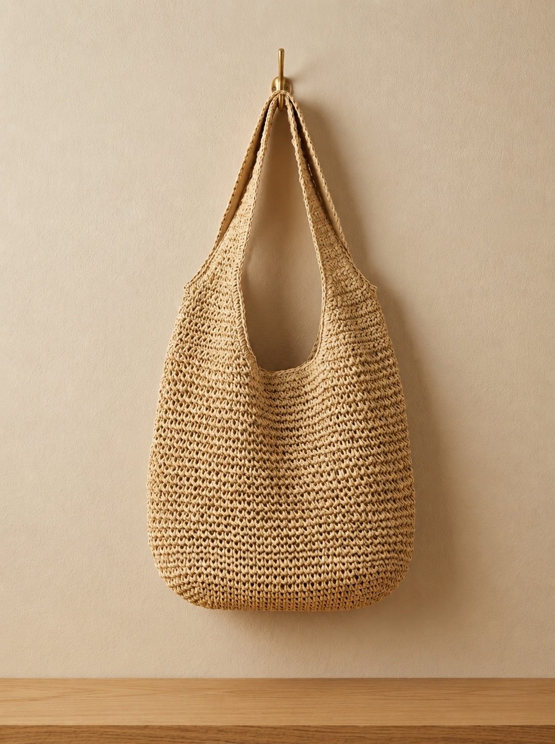 Foldable Straw Tote Bag hanging from a wall hook, showing its full shape