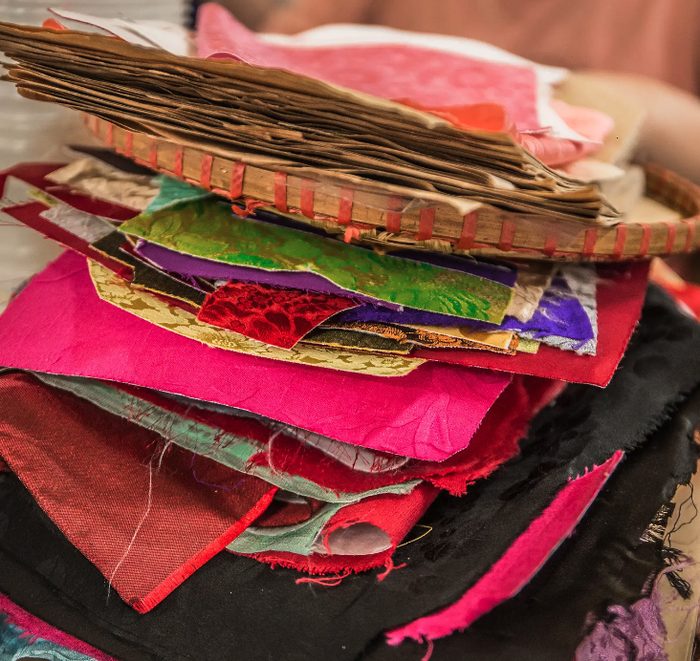 A stack of sorted silk scraps and offcuts