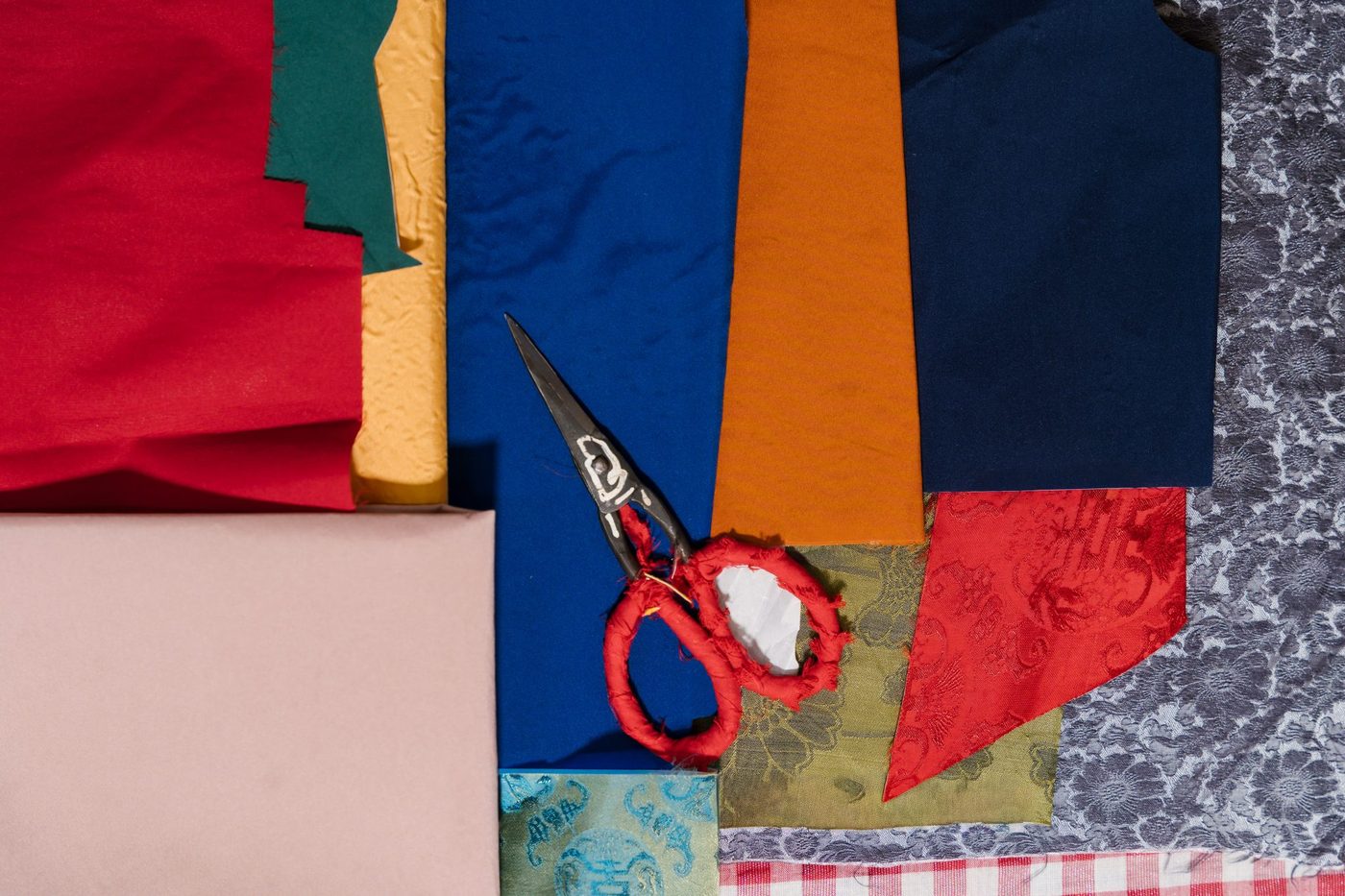 Silk offcuts sorted by color, ready for piecing